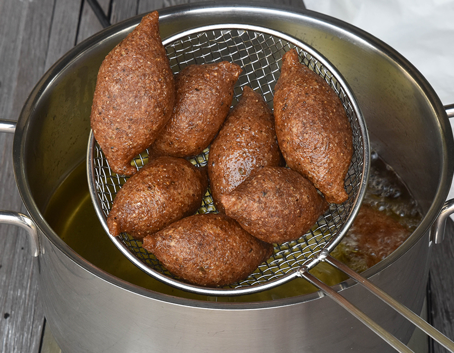 Fried Potato Kibbeh Balls...The outer shell  is made with mashed potatoes and kneaded with fine bulgur.  The dough is stuffed with a filling of minced beef or lamb and walnuts, seasoned with sumac, allspice, cinnamon powder and chili flakes